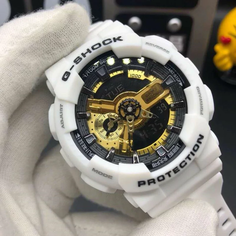 ساعت  مچی جی شاک سفید طلایی مدل GA-110GB-2A  جیشاک GShock، صد در صد ضدآب ، تنظیم اتوماتیک با پایتخت کشورها ، اتولایت دار